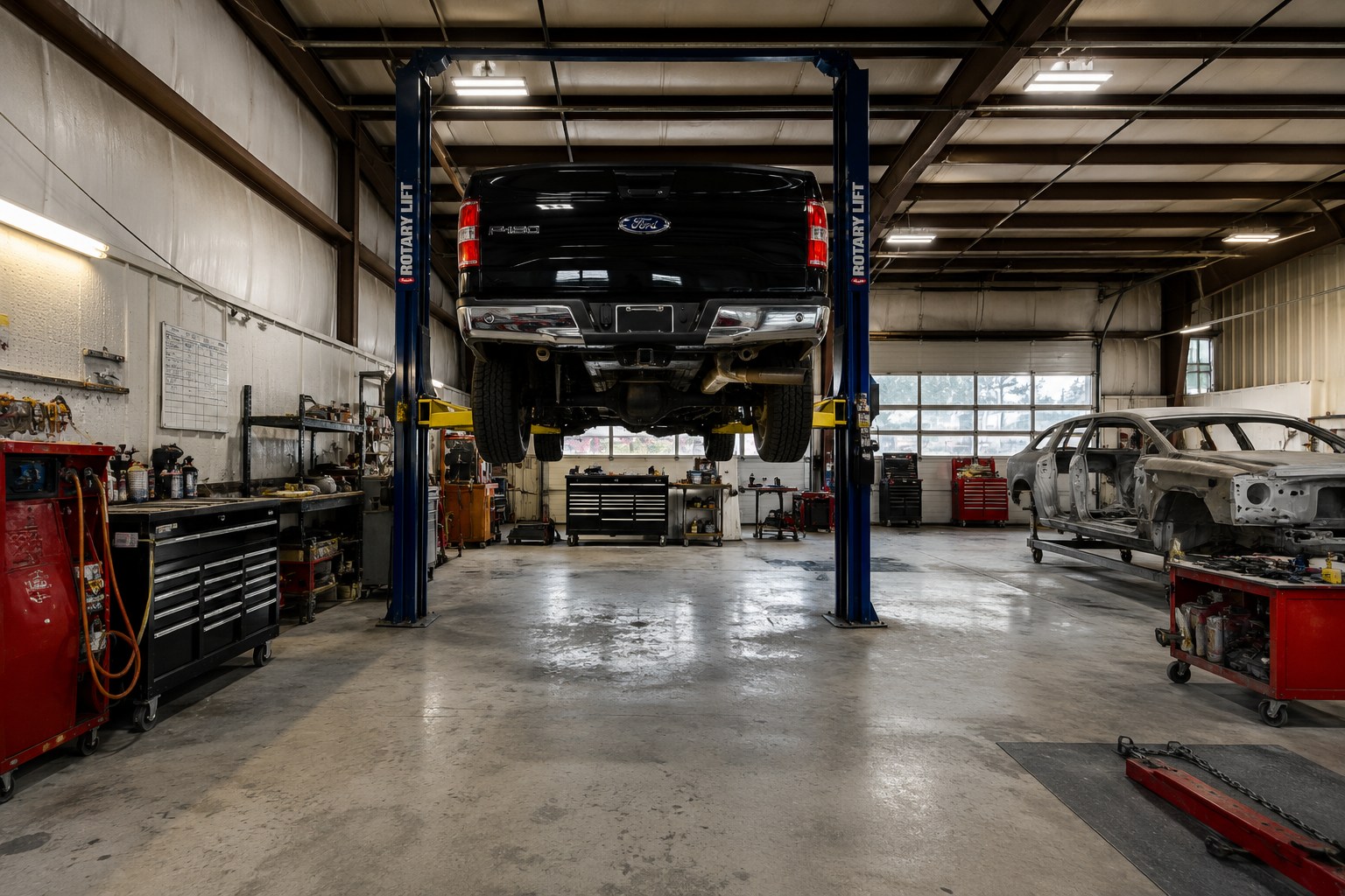 Service bay at Torvald Auto Service with a vehicle raised on a lift