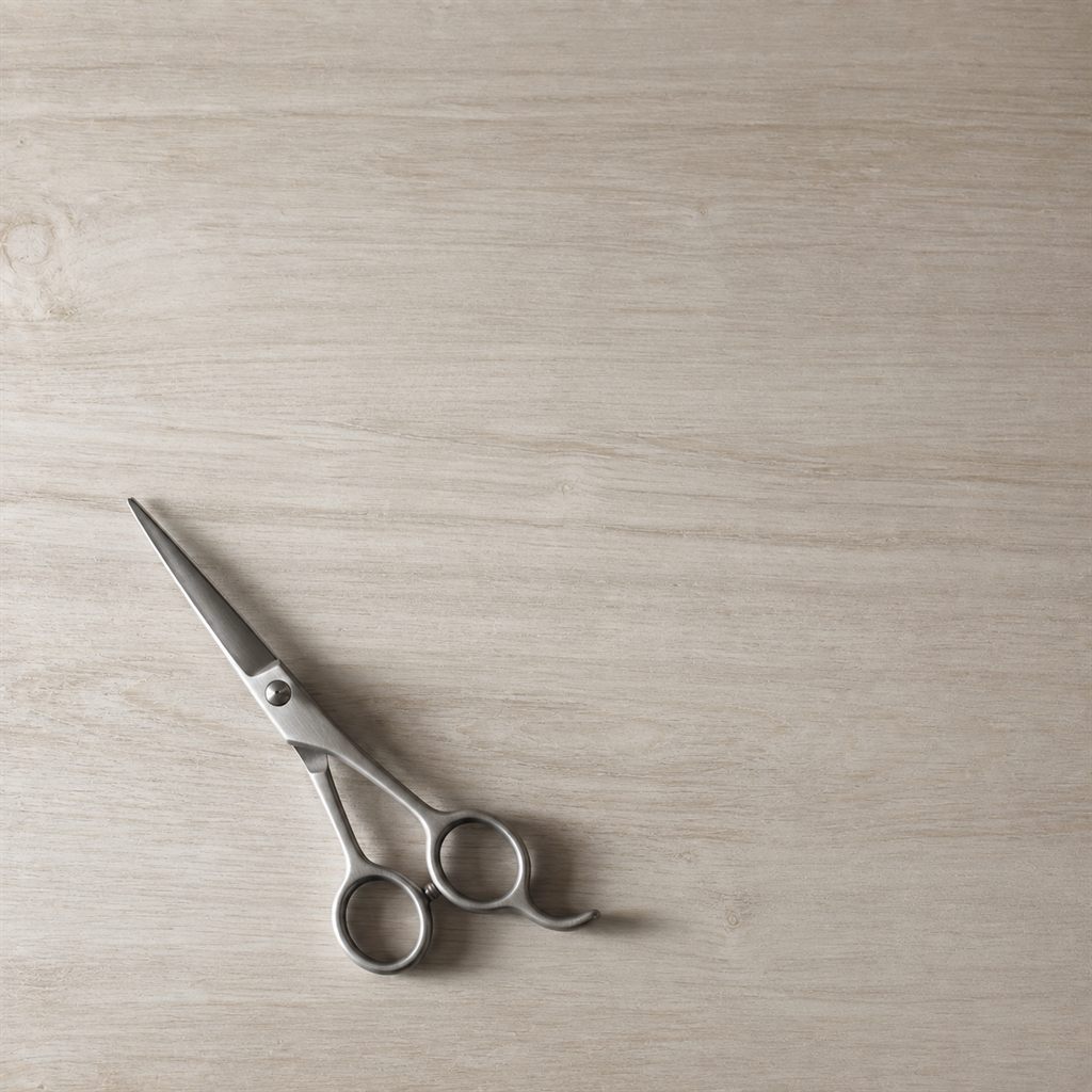 Shears resting on a pale wood shelf